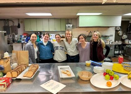 A few members of the Culinary Medicine club are pictured in the kitchen of their soup kitchen event. 