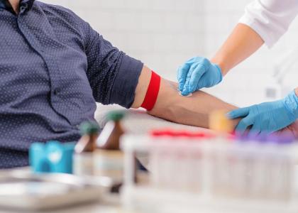 Patient having blood drawn from inside his elbow for a blood test