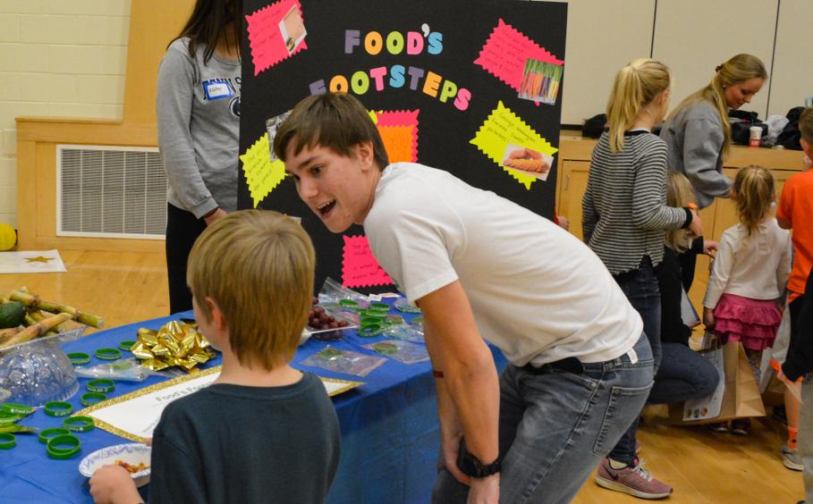 Student teaching kids about nutrition at a local elementary school. 