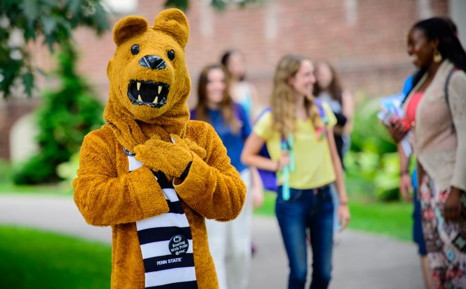 The Lion mascot with students. 