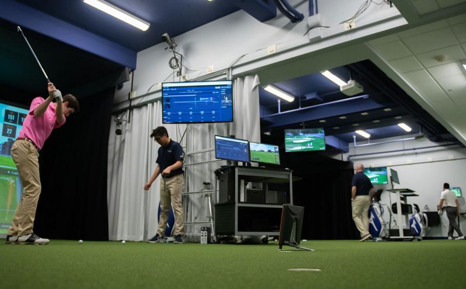 Wide angle view of all three bays in the Golf and Teaching Research Center. Students and faculty are engaged in activities specific to each bay.