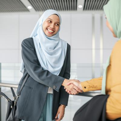 Asian muslim businesswomen meet and handshaking