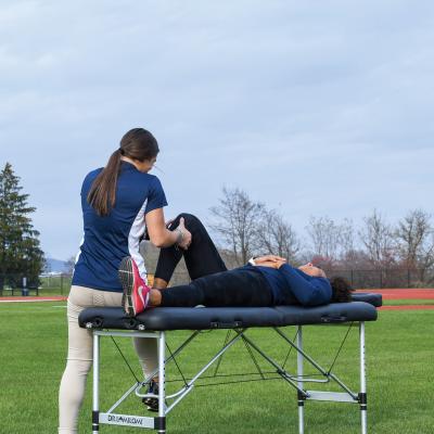 Trainer checking in with athlete before a track event.