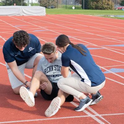 Trainers tend to an injured runner