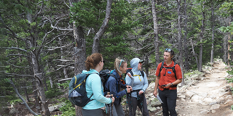 Derrick Taff speaking with hikers on a trail