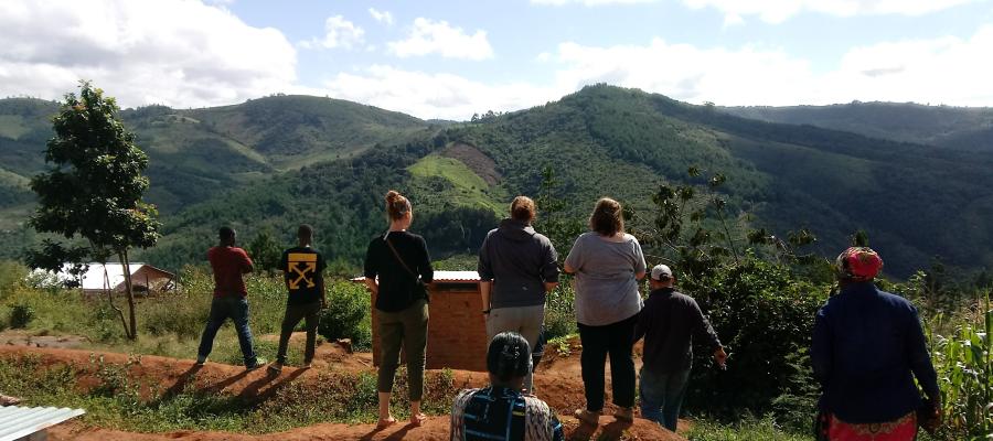 Global Health Minor students overlooking a valley in Tanzania where a water project is located