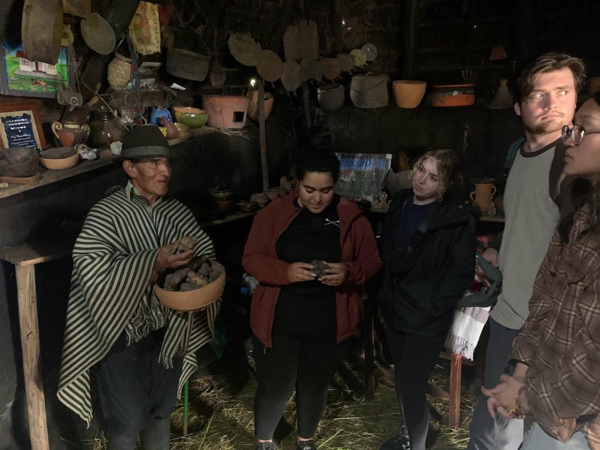 =Students in an Andean shop with the seller