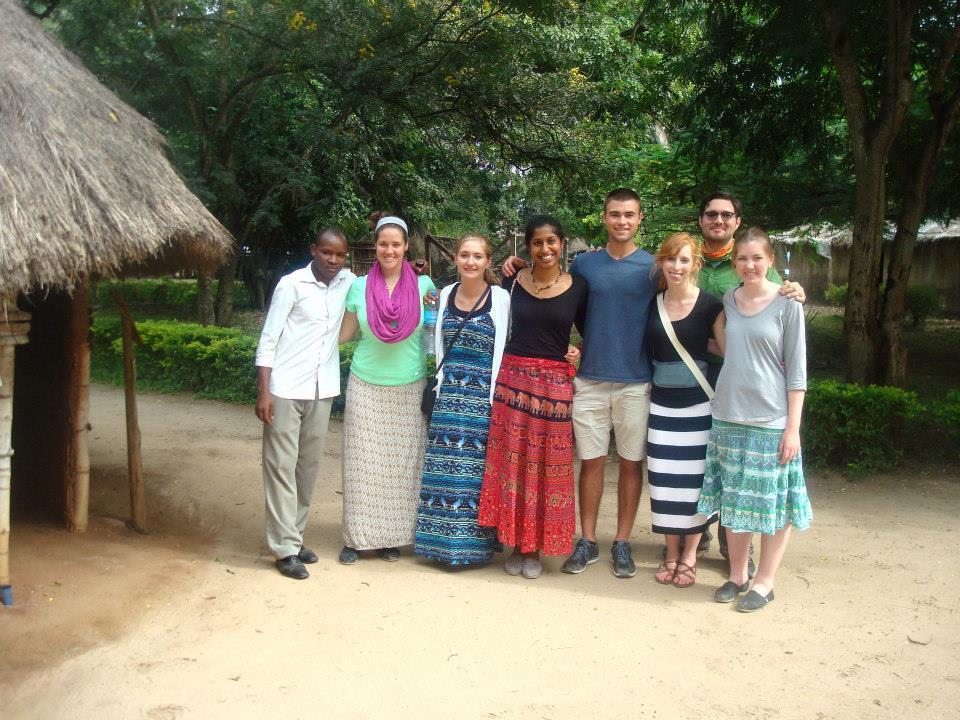 =Group of students standing in a village in Tanzania