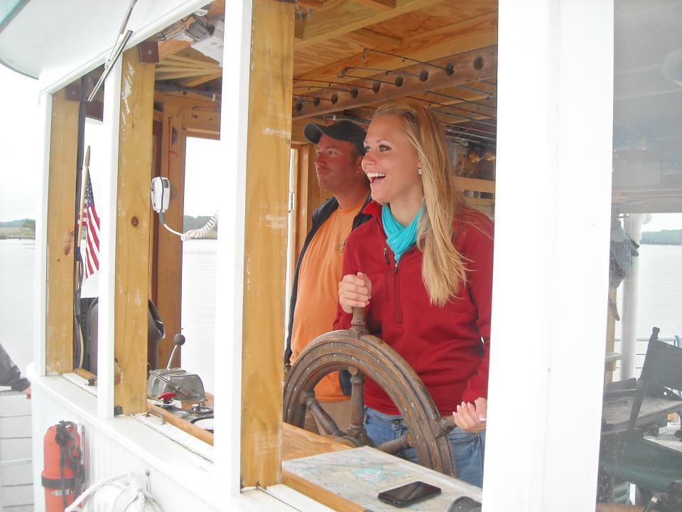 =Female student sails an oyster boat during the Sailing the Chesapeake class